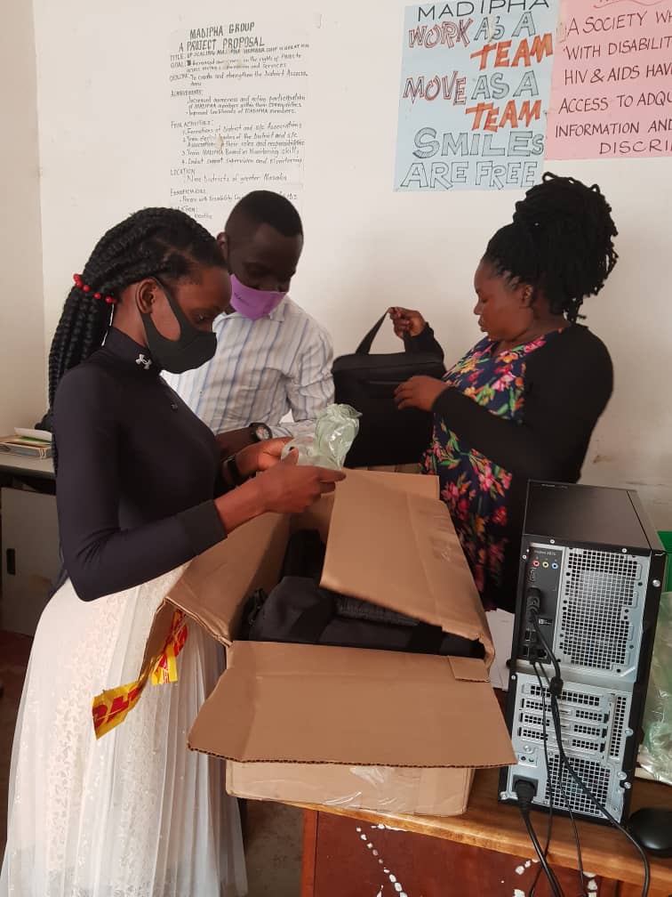 Fellow Nissy Namuyomba opens a storytelling kit at her offices in Uganda.