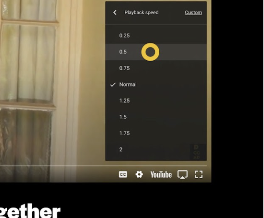 A dialog box above the bottom right corner of a YouTube player contains the following items in vertical order: "Playback speed [-] Custom" "0.25", "0.5", "0.75", "Normal", "1.25", "1.5", "1.5", "1.75", "2". There is a tick next to "Normal" and a yellow circle icon highlights "0.5".