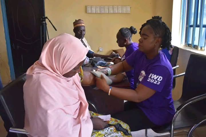 Esther Mejedi takes a patient's blood pressure.