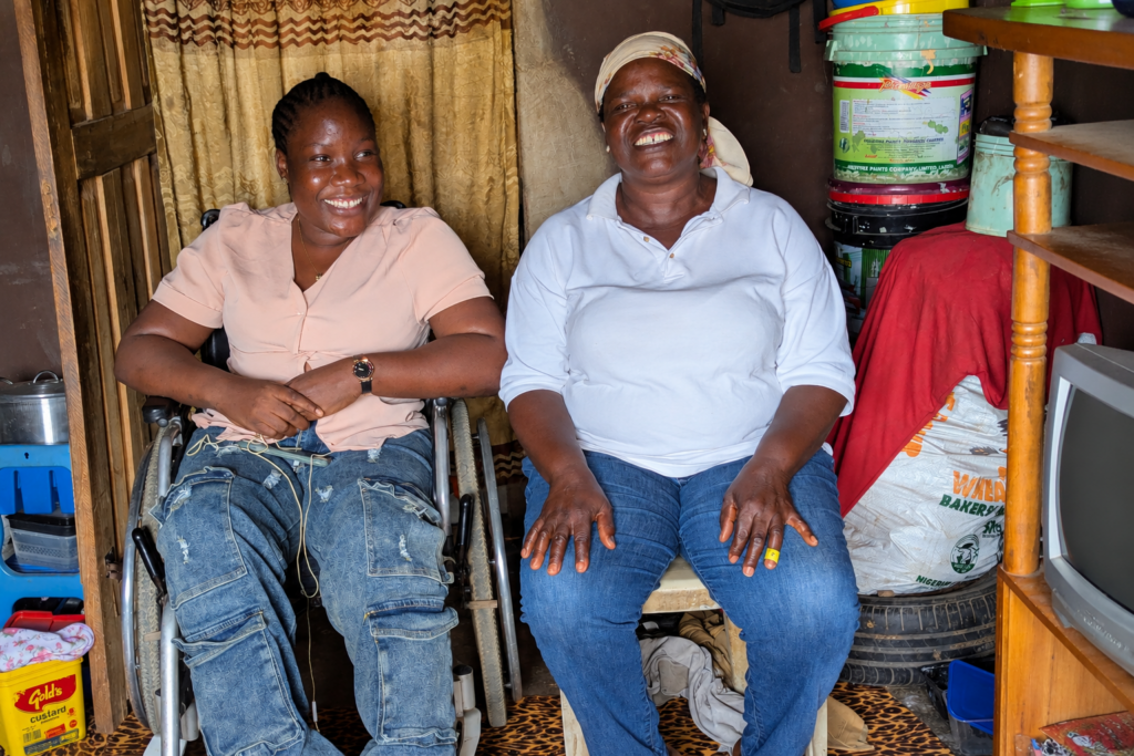Aliya Yusuf, a young Nigerian woman in a wheelchair, smiles alongside her mother, Balikis Yusuf, in their home in Lagos, Nigeria.