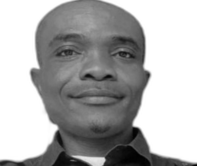 Alexander Ogheneruemu, a Deaf Nigerian man wiht closely cropped hair, smiles into the camera.
