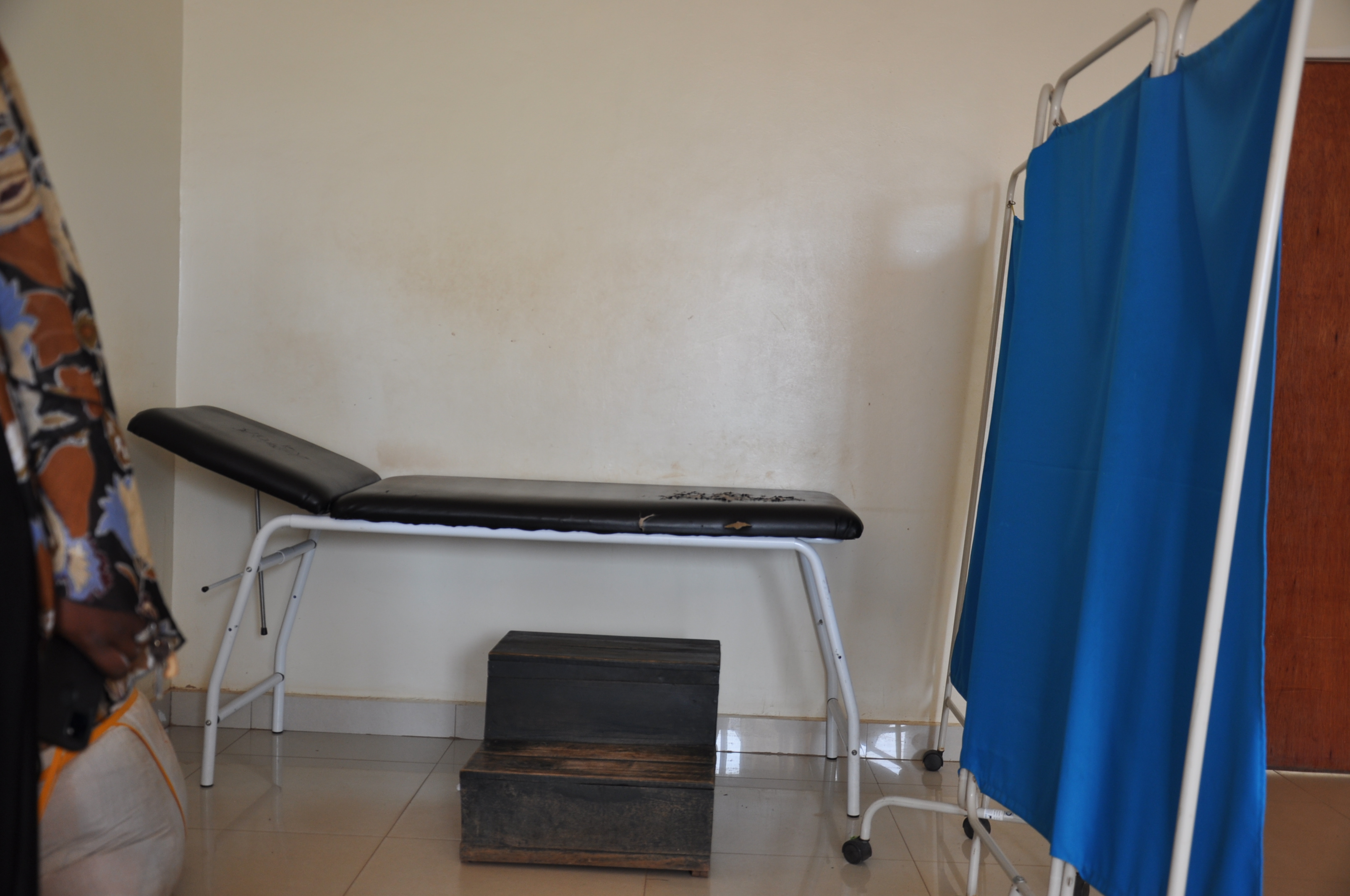 A step stool underneath a bed in a health center in Rwanda.