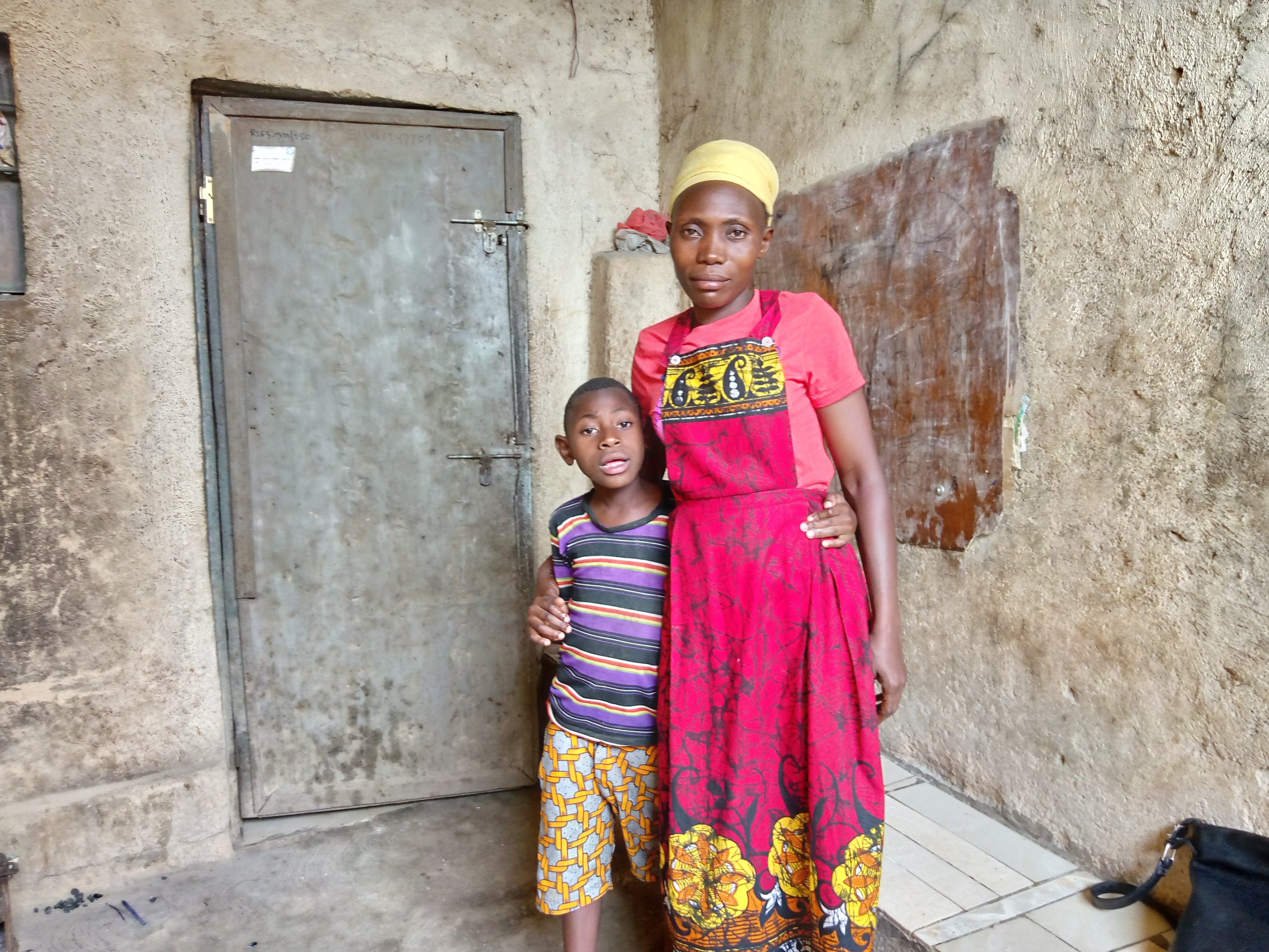 Pacifique Uwizeyimana stands with her arm around her son, Samuel Fils Imanigiraneza.