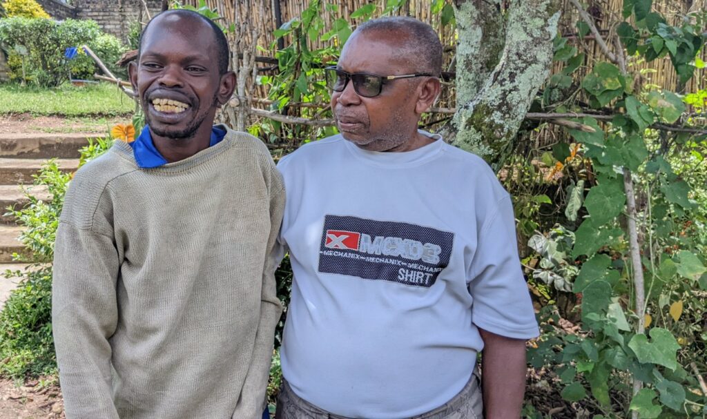 Edouard Niyonteze stands outside with his his son, Dominic Hirwa.