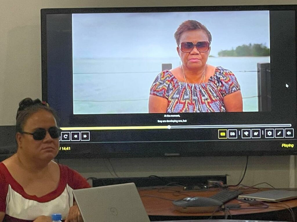 Mataafa Faatino Utumapu, NOLA’s general manager, sits in front of a larger monitor playing Rising Tides, Raising Voices.