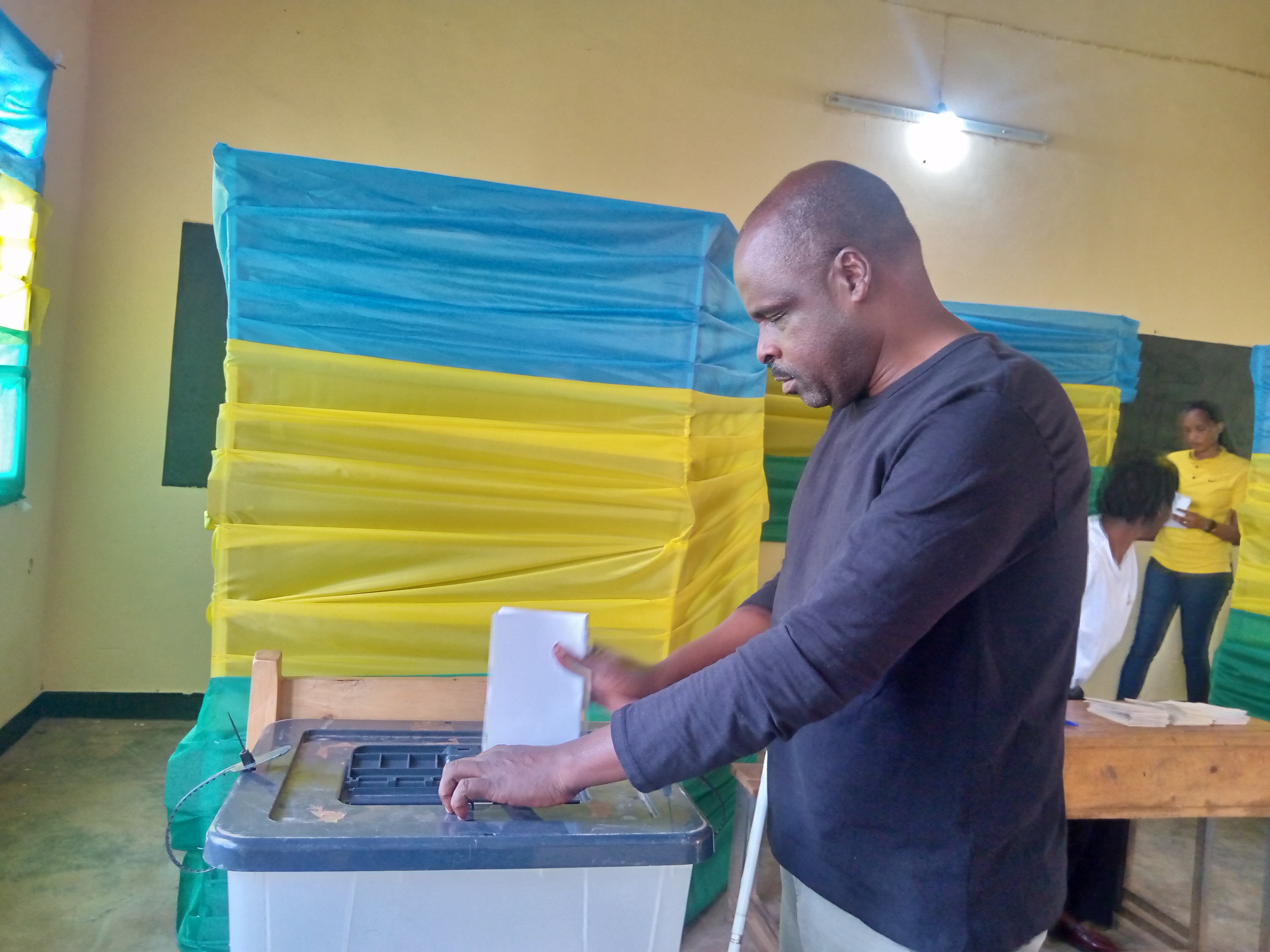 Jean Marie Vianney Mukeshimana, a blind Rwandan man, votes with a Braille ballot.