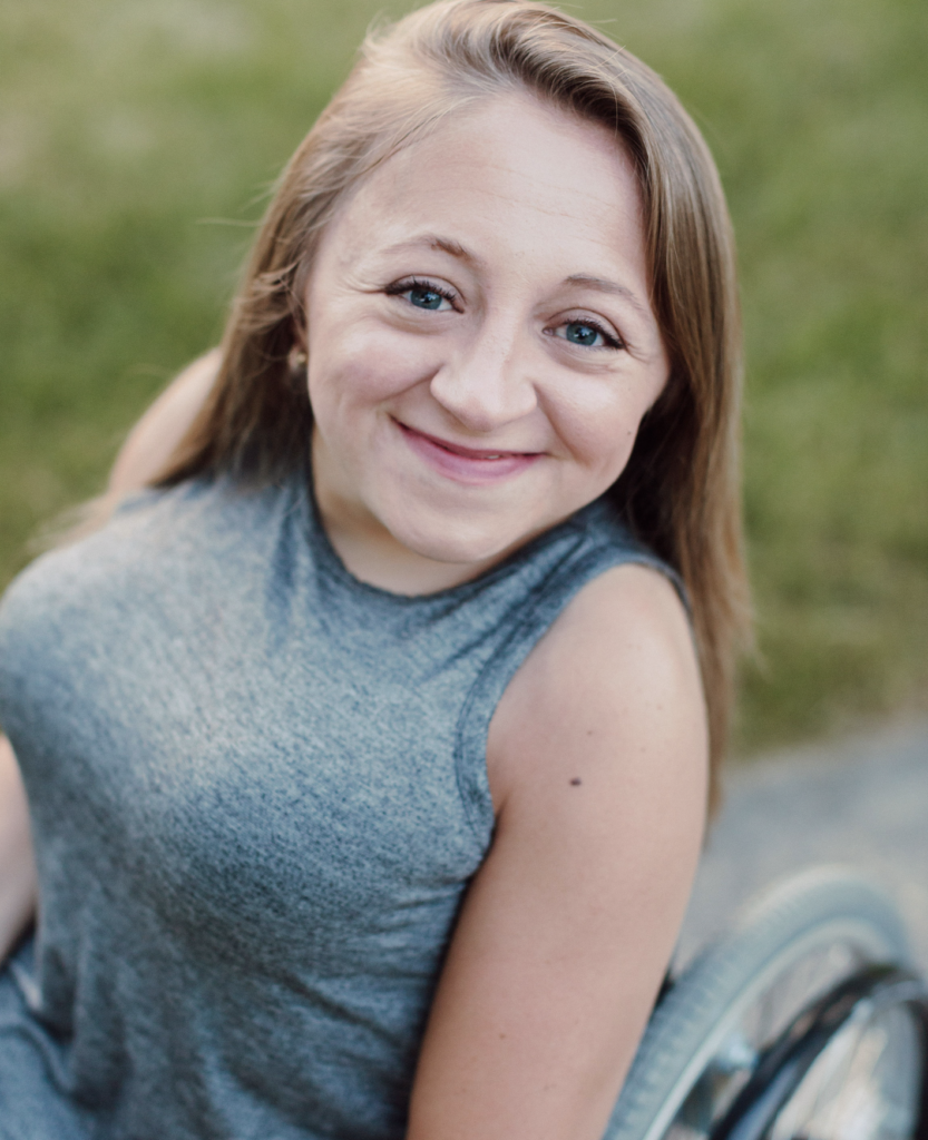 Emily Voorde smiles from her wheelchair.