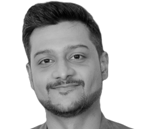 Aalap Deboor, a young Indian man, smiles at the camera. He has dark hair swept to the side and a goatee.