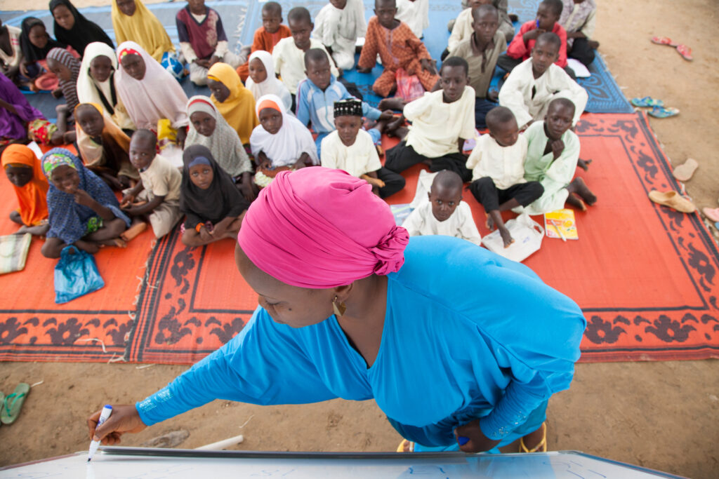 A teacher in a classroom with children in Nigeria.