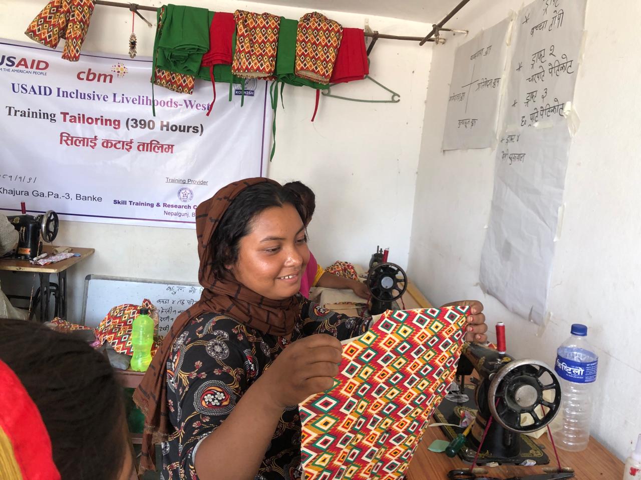 Lakshmi Lohar sews clothes in Nepal.