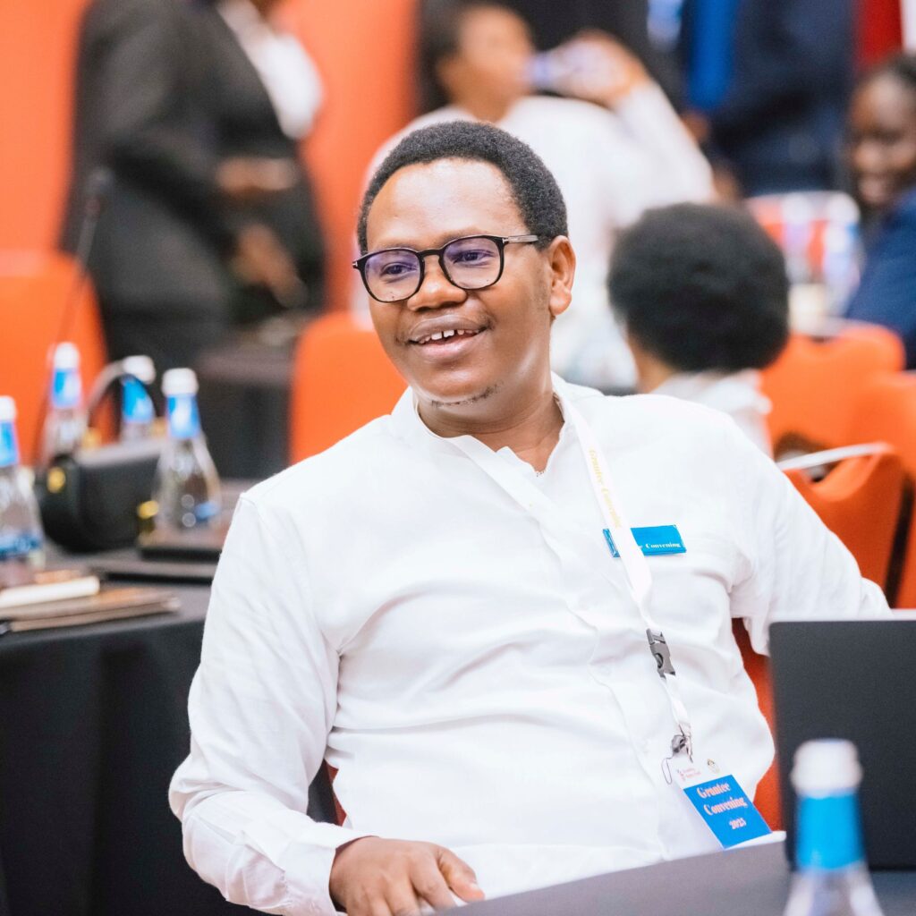 Jean Pierre Sibomana, a former Uganda program officer with the Disability Rights Fund, wears glasses and has dark, closely cropped hair.