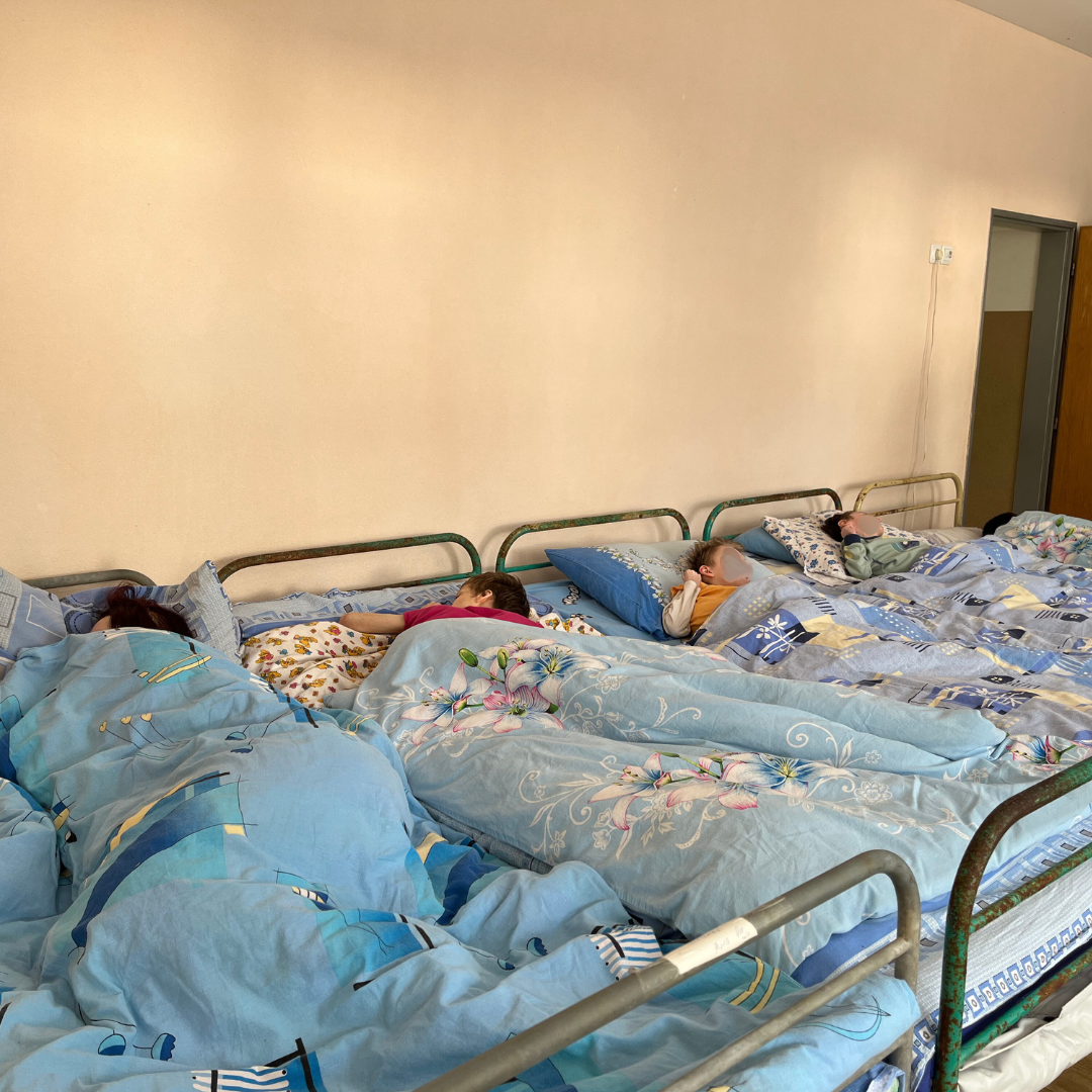 Young boys lined up in beds in an institution in Ukraine.