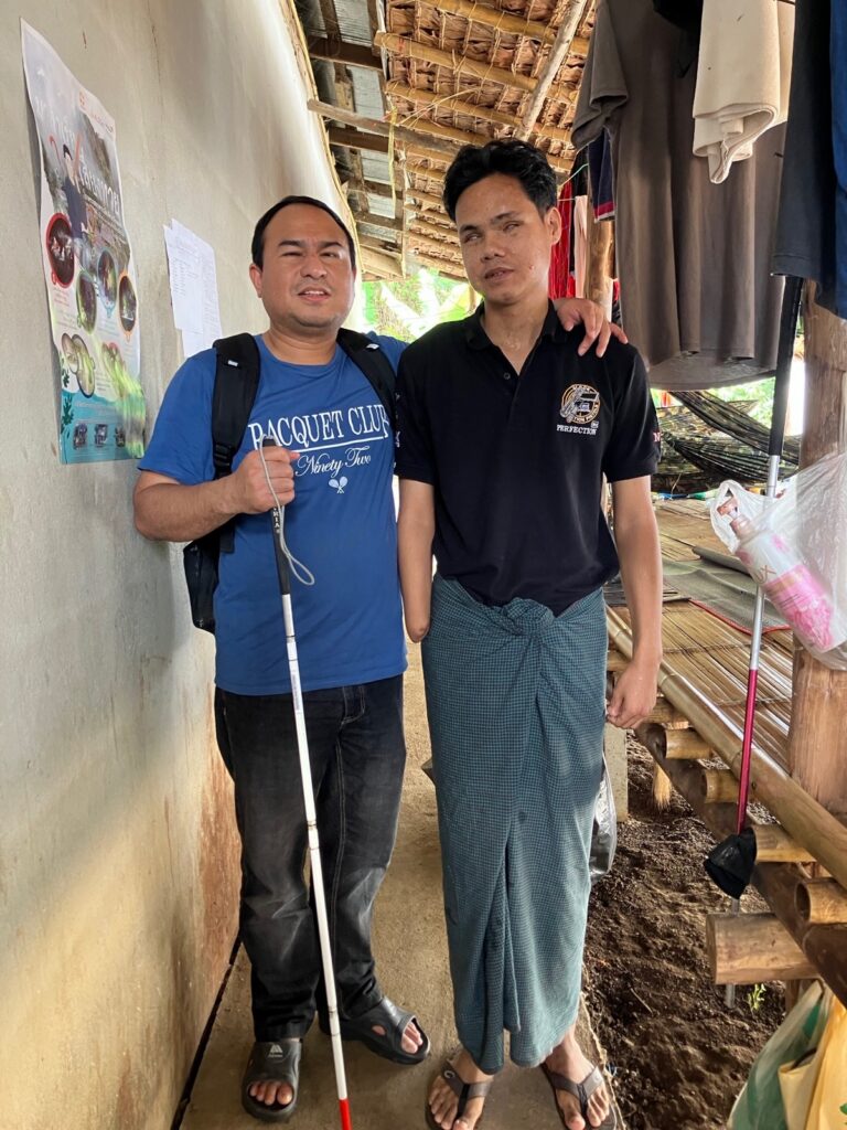 Brian Zaw stands with a former PDF soldier in Thailand.