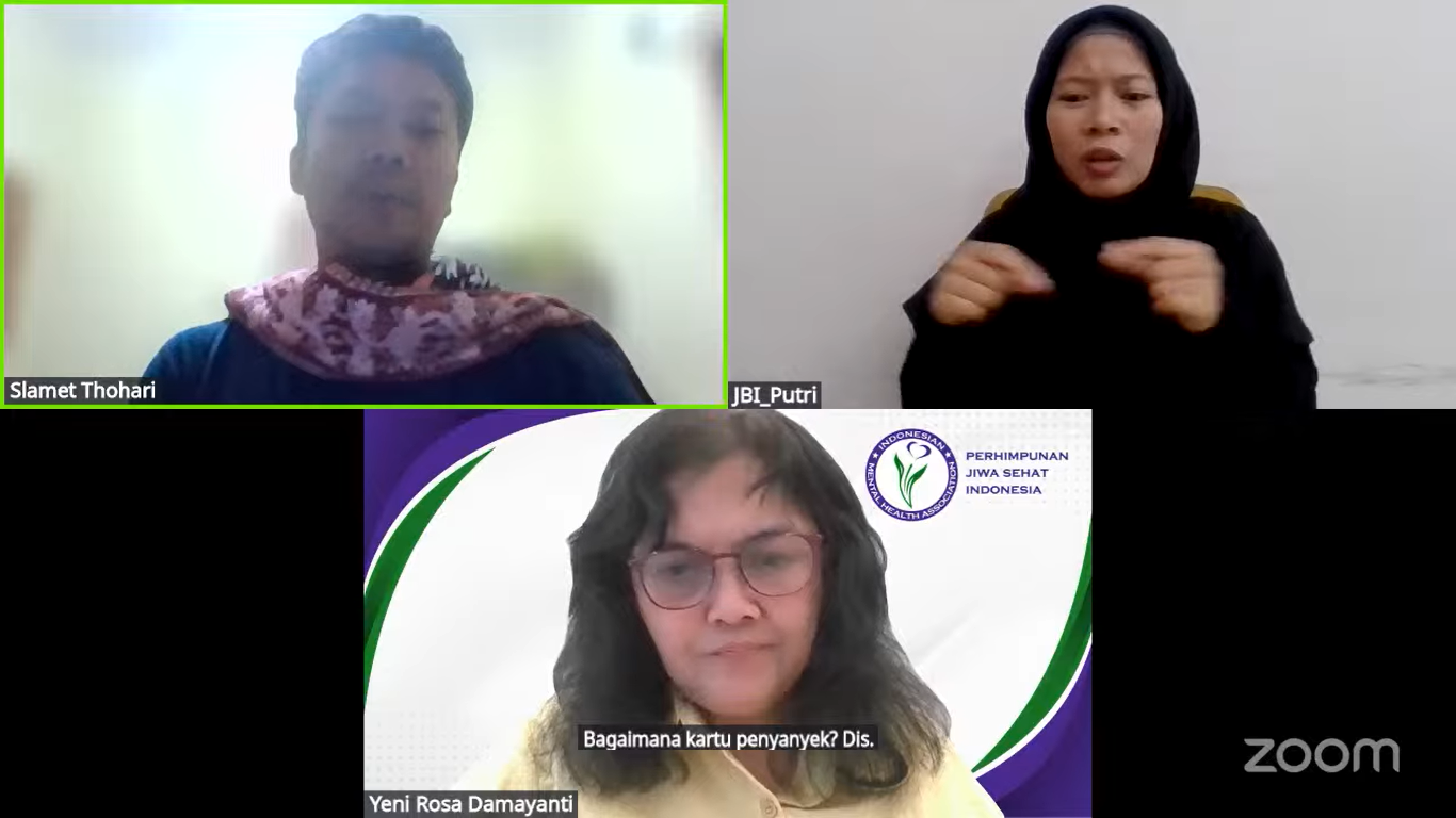 Yeni Rosa Damayanti speaks during an online forum on Indonesia’s Disability Card and Disability Certificate system. A sign language interpreter and another participant appear on screen.